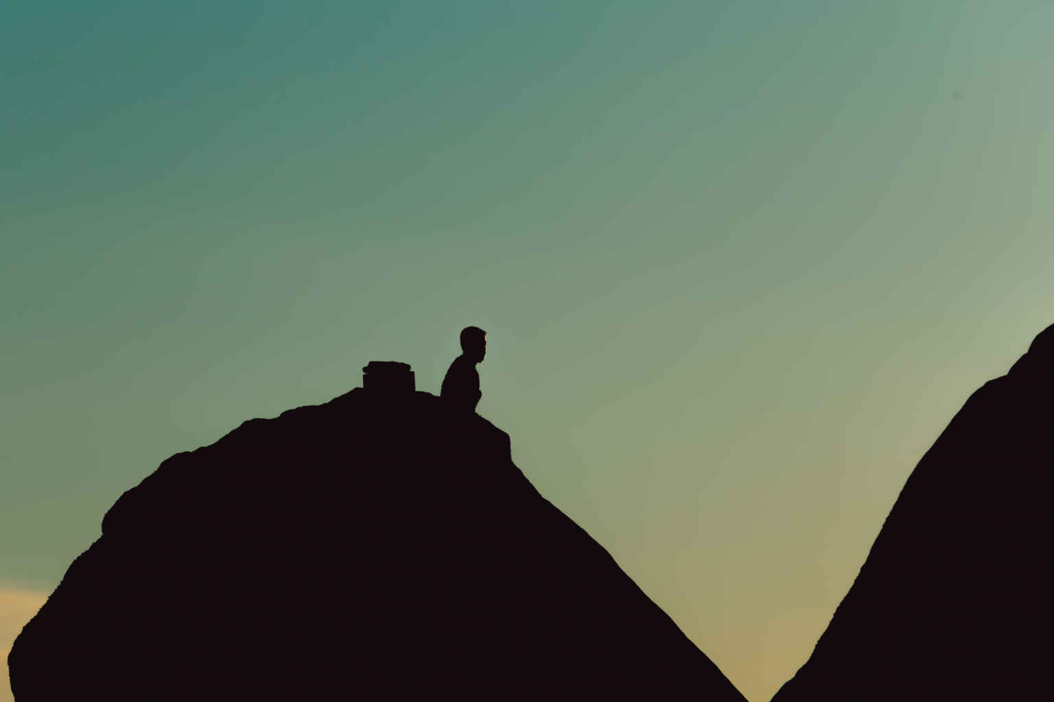 silhouette of a man over a mountain during a blue 2022 02 25 23 37 06 utc